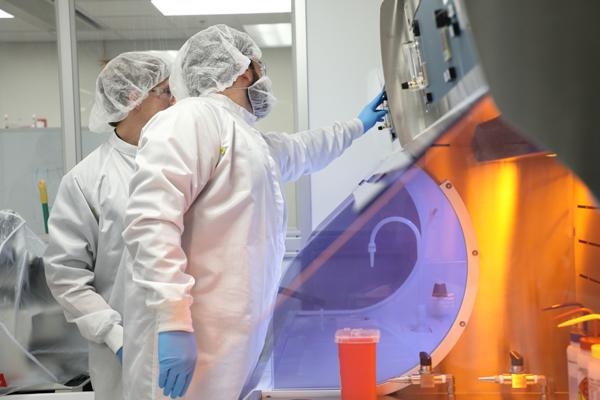 Two people using equipment in a nano-technology lab