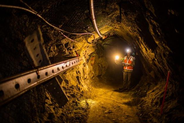 A person flying a drone in an underground mine.